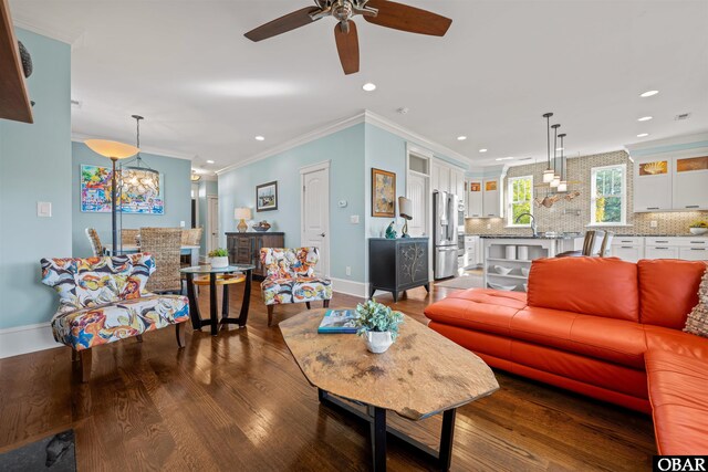 living room with crown molding, recessed lighting, wood finished floors, and baseboards