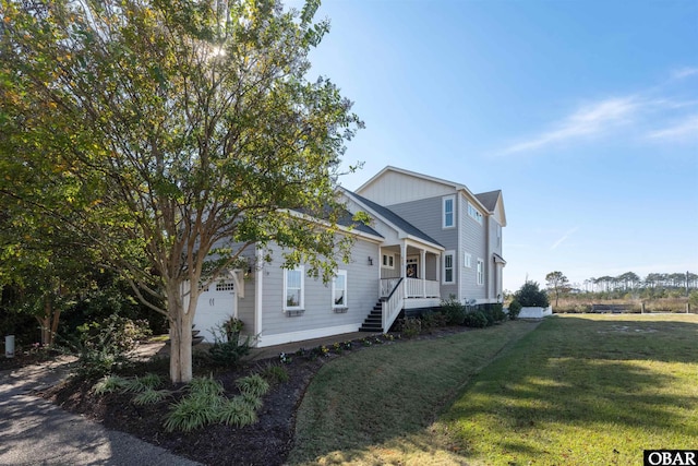 view of front facade with an attached garage, a porch, and a front lawn