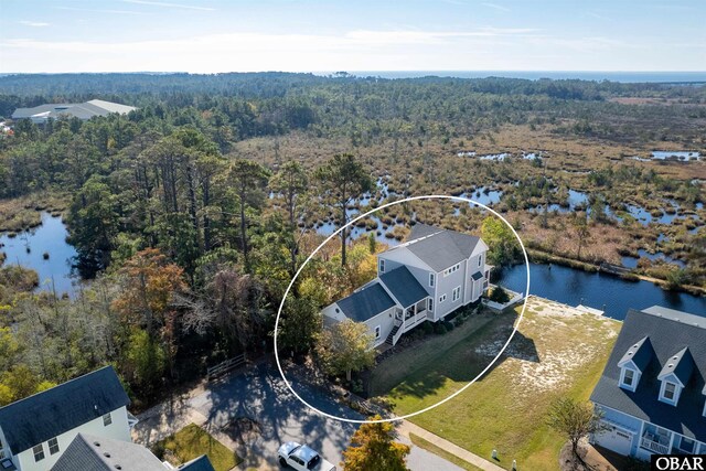 aerial view with a forest view and a water view