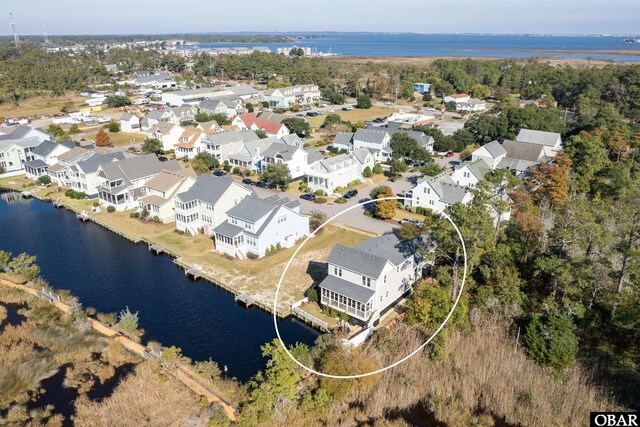 birds eye view of property with a residential view and a water view