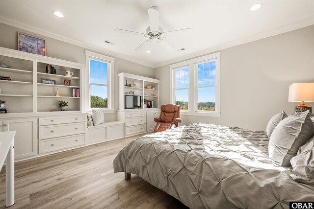 bedroom with multiple windows, crown molding, and light wood-type flooring