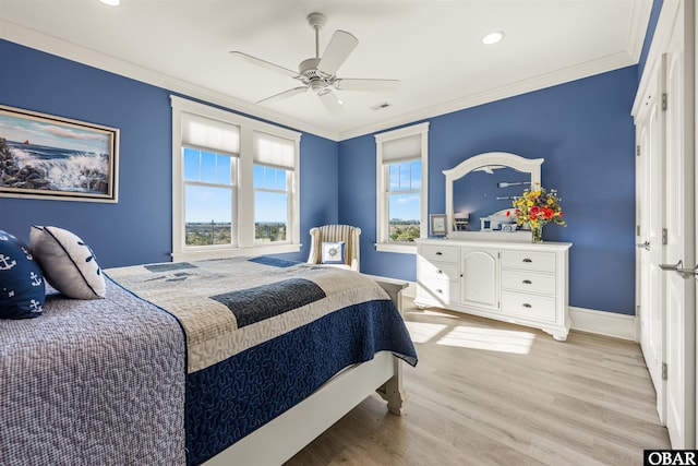 bedroom featuring visible vents, ceiling fan, baseboards, light wood-type flooring, and ornamental molding