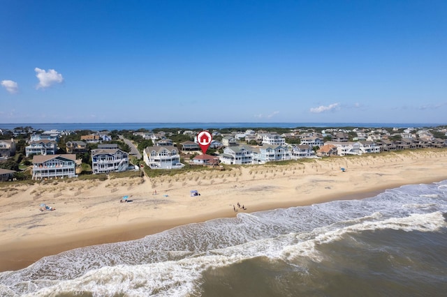 birds eye view of property featuring a residential view, a water view, and a beach view