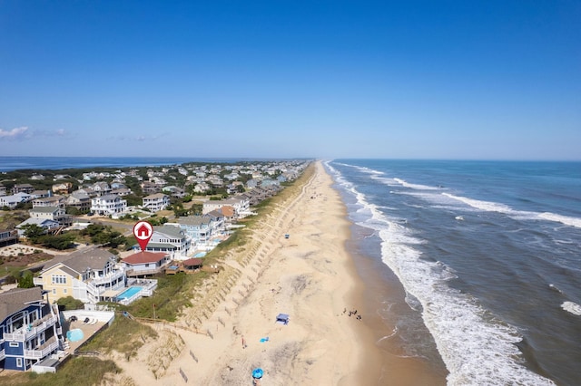 birds eye view of property with a water view, a residential view, and a view of the beach