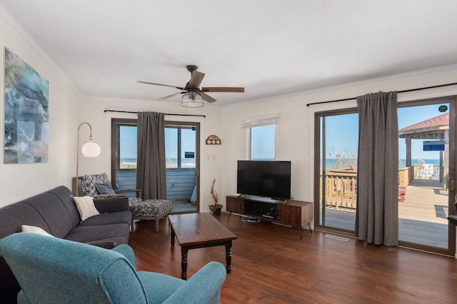 living room featuring ornamental molding, dark wood finished floors, and a ceiling fan