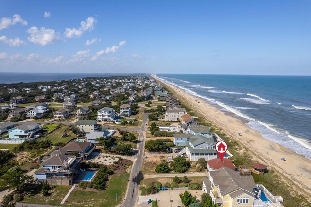 aerial view with a water view, a residential view, and a beach view