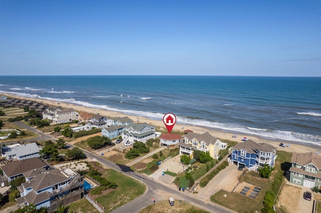 bird's eye view with a residential view, a water view, and a beach view