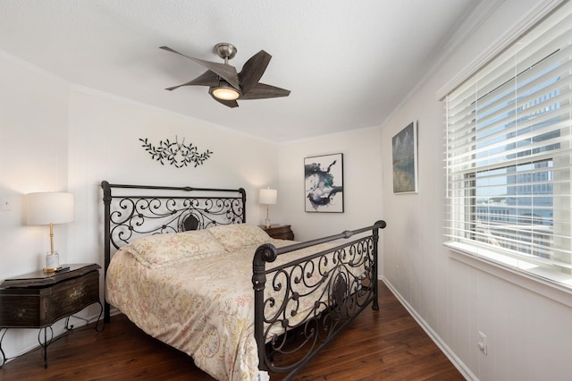 bedroom with dark wood-style floors, a ceiling fan, and crown molding