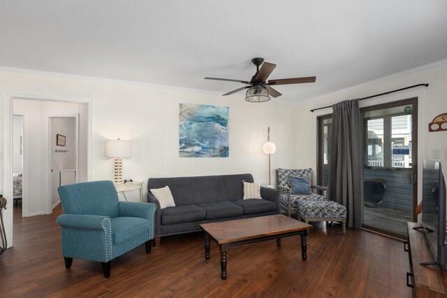 living area featuring ornamental molding, ceiling fan, and dark wood-type flooring