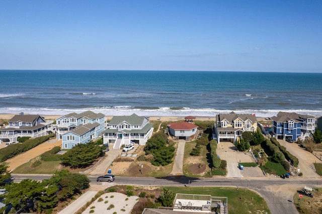 bird's eye view with a water view, a residential view, and a view of the beach