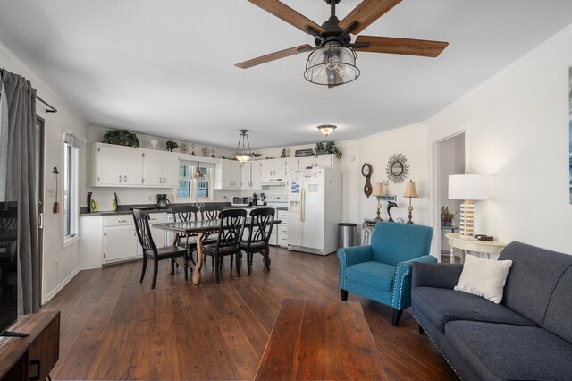 dining area with a ceiling fan, dark wood-style flooring, and crown molding