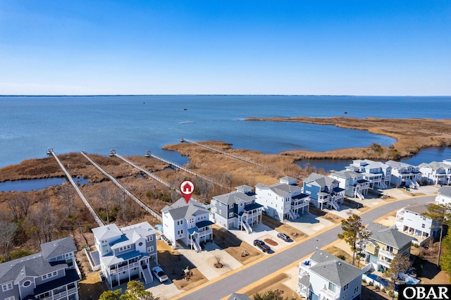 birds eye view of property with a water view and a residential view