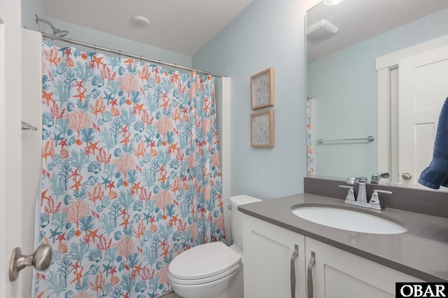 bathroom featuring toilet, a shower with curtain, and vanity