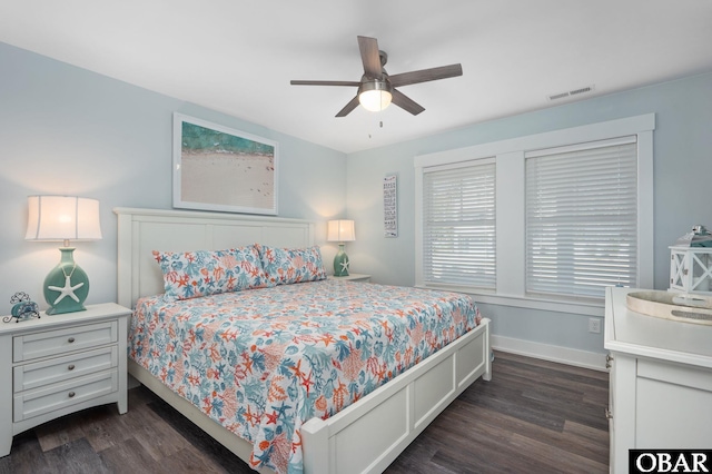 bedroom featuring dark wood-style flooring, visible vents, ceiling fan, and baseboards