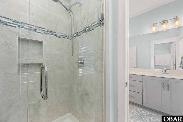 bathroom with a stall shower and vanity