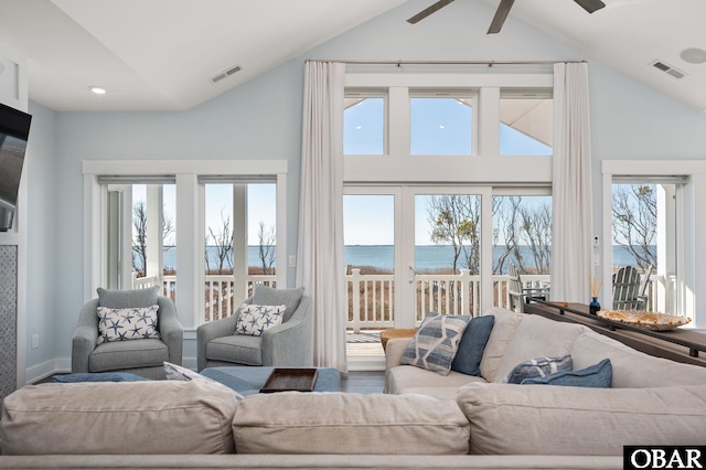 living area with a healthy amount of sunlight, visible vents, and ceiling fan