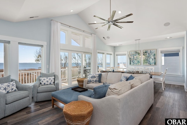 living room featuring dark wood-style flooring, a notable chandelier, recessed lighting, visible vents, and high vaulted ceiling