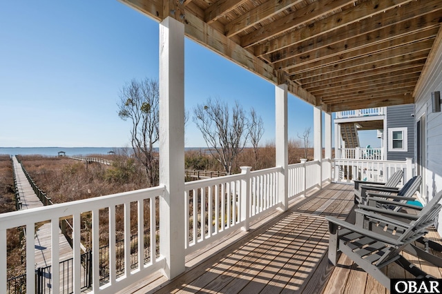 wooden deck featuring a water view