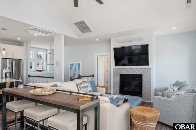 living area with a fireplace, visible vents, dark wood-style flooring, and recessed lighting