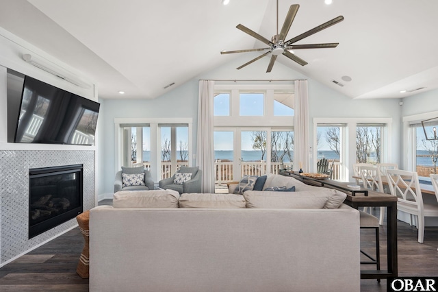 living area with visible vents, a glass covered fireplace, dark wood finished floors, and recessed lighting