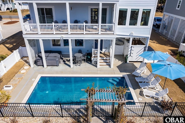 rear view of house featuring a patio, a fenced backyard, a jacuzzi, a gate, and a fenced in pool