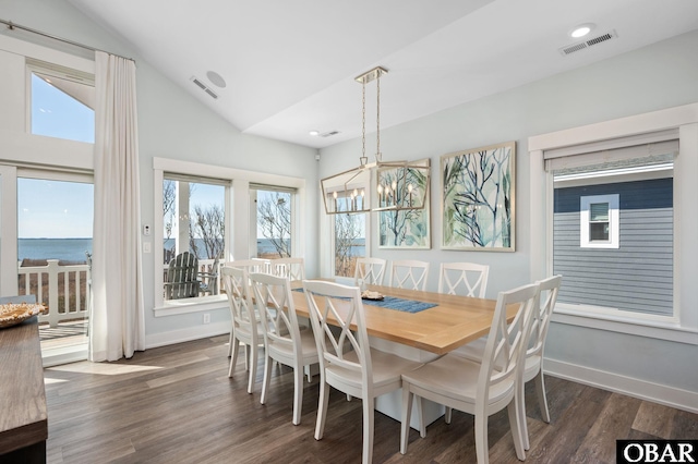 dining area featuring lofted ceiling, dark wood-style flooring, visible vents, and baseboards