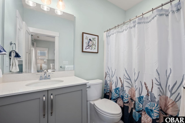 bathroom with toilet and vanity