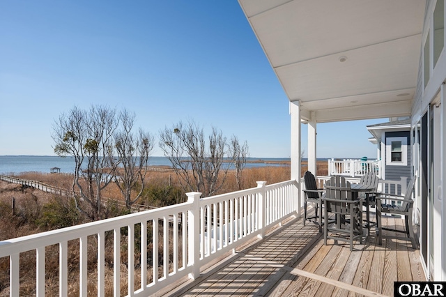 wooden terrace featuring a water view