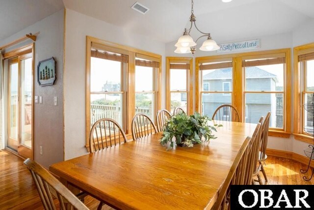 dining room with visible vents, baseboards, and wood finished floors