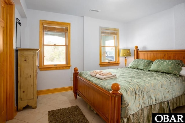 bedroom featuring visible vents, baseboards, and light tile patterned flooring