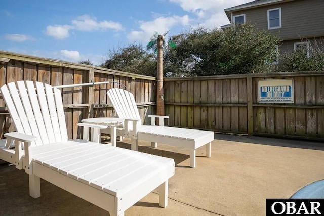 view of patio featuring fence