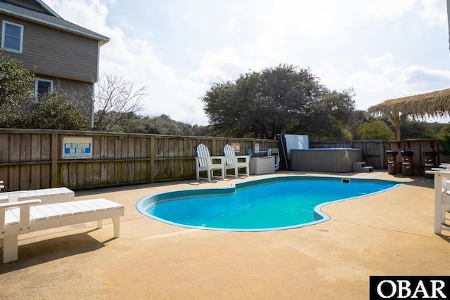 view of pool featuring a patio area, a fenced in pool, and a fenced backyard