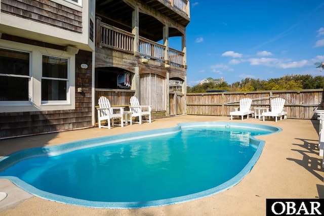 view of pool with a fenced in pool, a patio area, and fence