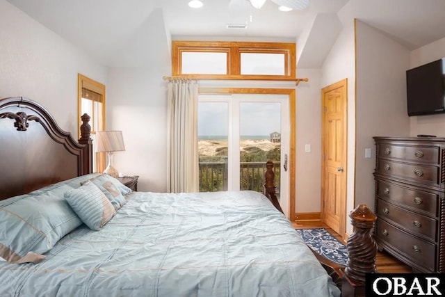 bedroom featuring access to exterior, visible vents, and wood finished floors