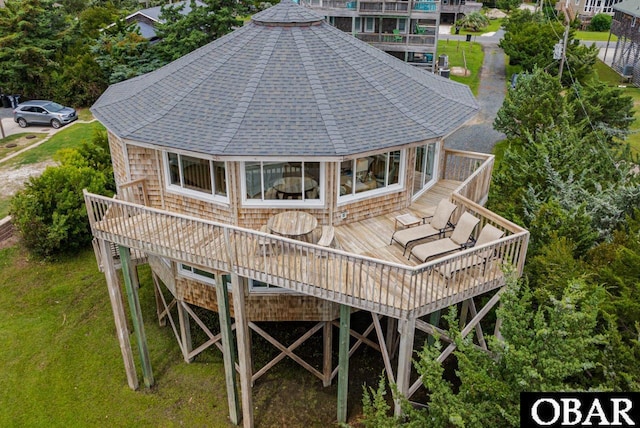 rear view of house with a shingled roof and a wooden deck