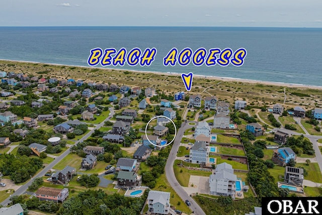 bird's eye view featuring a water view and a view of the beach