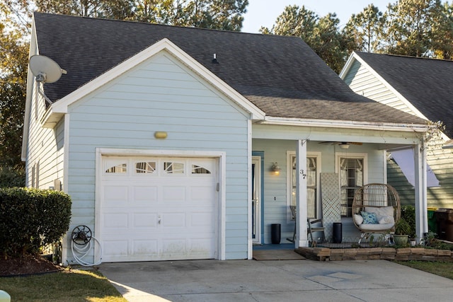 view of front of home with concrete driveway, an attached garage, covered porch, and a shingled roof