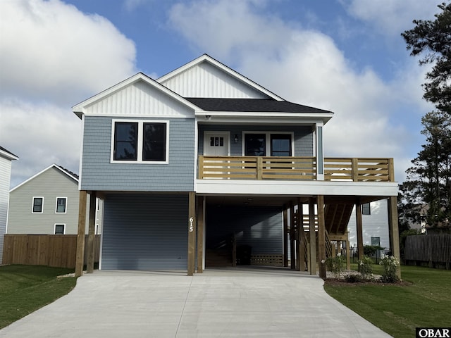 615 W Aycock St Unit 5-7, Kill Devil Hills, NC 27948 - coastal home featuring board and batten siding, a carport, and driveway