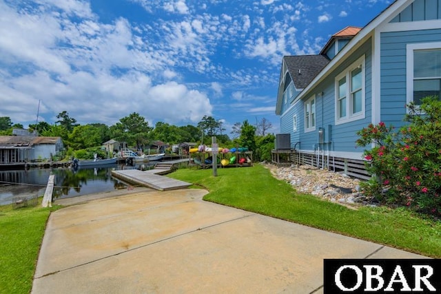 105D Colington Pointe Cir Unit 104-D, Kill Devil Hills, NC 27948 - view of green lawn featuring a water view and a dock