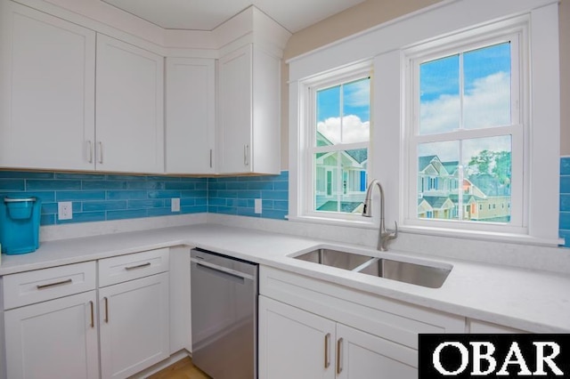 105D Colington Pointe Cir Unit 104-D, Kill Devil Hills, NC 27948 - kitchen with dishwasher, white cabinets, light countertops, and tasteful backsplash