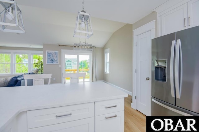 105D Colington Pointe Cir Unit 104-D, Kill Devil Hills, NC 27948 - kitchen with stainless steel refrigerator with ice dispenser, light wood-type flooring, healthy amount of natural light, light countertops, and vaulted ceiling