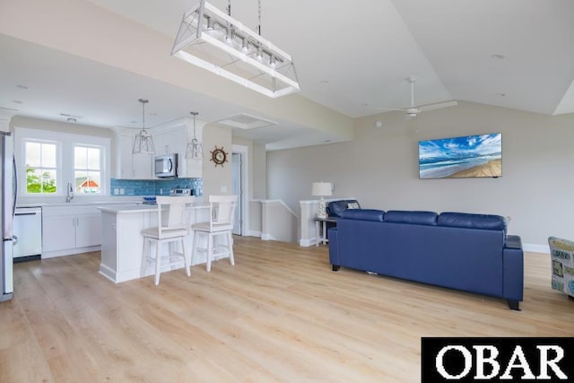 105D Colington Pointe Cir Unit 104-D, Kill Devil Hills, NC 27948 - living room featuring light wood finished floors and vaulted ceiling