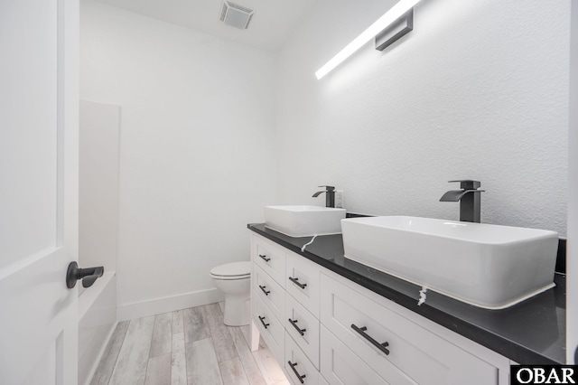 2002 Sandpiper Rd Lot 12, Corolla, NC 27927 - bathroom featuring wood finished floors and double vanity