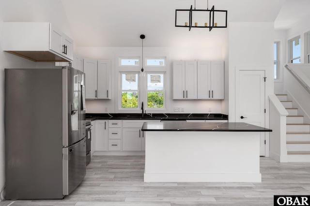 2002 Sandpiper Rd Lot 12, Corolla, NC 27927 - kitchen featuring stainless steel fridge, dark countertops, hanging light fixtures, and light wood finished floors
