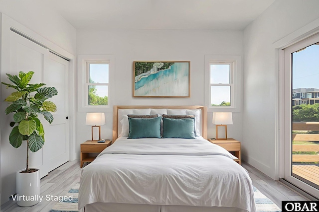 2002 Sandpiper Rd Lot 12, Corolla, NC 27927 - bedroom featuring multiple windows, light wood-style flooring, and access to outside