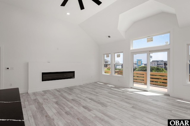 2002 Sandpiper Rd Lot 12, Corolla, NC 27927 - unfurnished living room with a glass covered fireplace, a ceiling fan, high vaulted ceiling, light wood finished floors, and recessed lighting