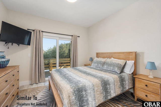 bedroom featuring access to outside and baseboards