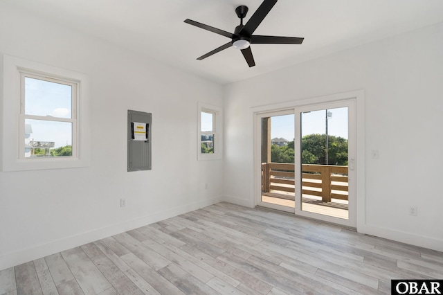 2002 Sandpiper Rd Lot 12, Corolla, NC 27927 - empty room with healthy amount of natural light, electric panel, ceiling fan, and light wood-style flooring