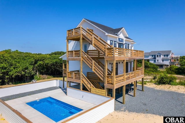2002 Sandpiper Rd Lot 12, Corolla, NC 27927 - back of house featuring stairs, a deck, and a jacuzzi