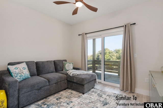 living area with a ceiling fan, baseboards, and light wood finished floors